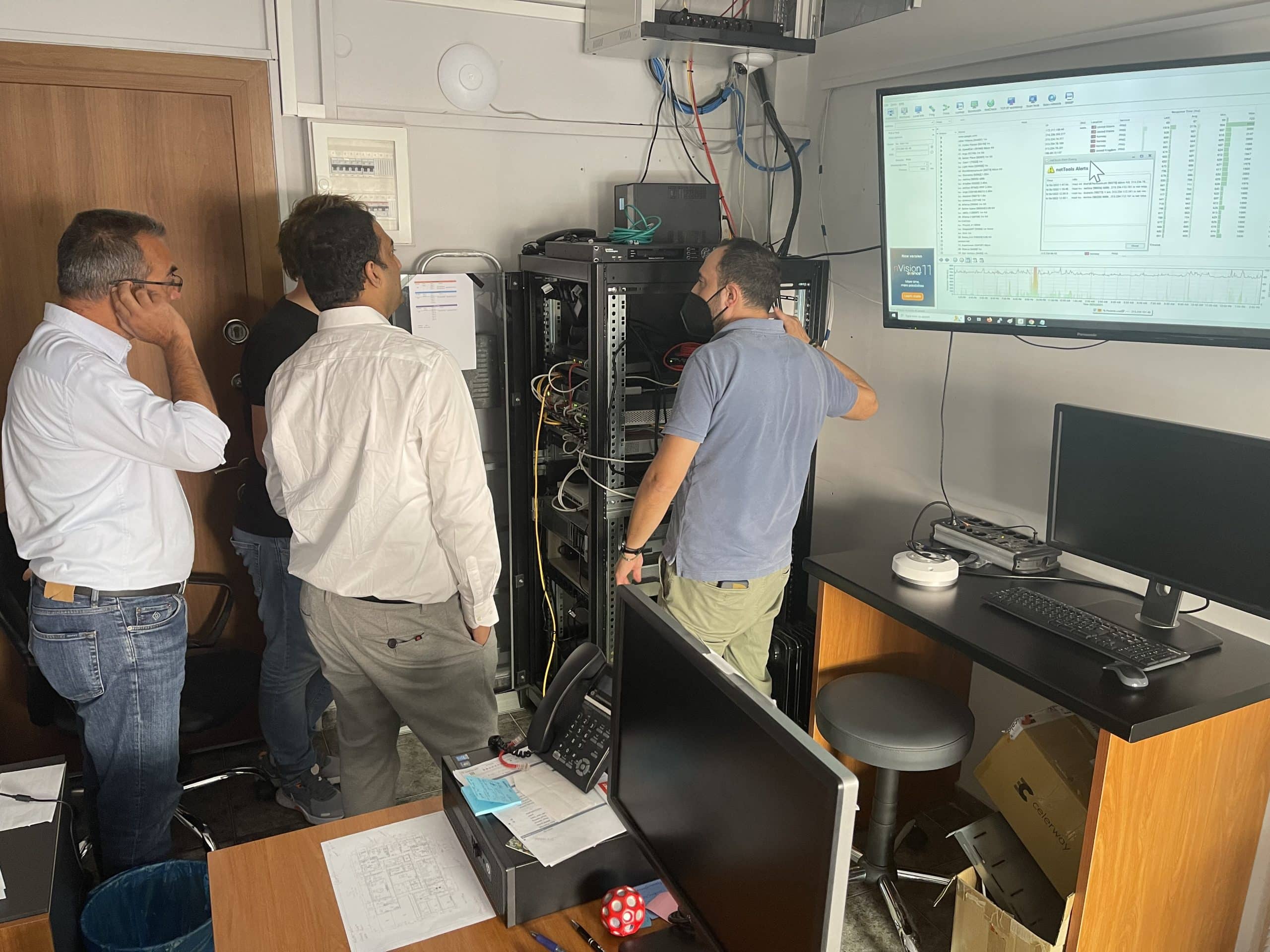 Caption: Telenor Satellite and Marel teams of experts perform final checks of the configuration. (At the front, left to right: Thanos Kyrtatas, Communications and IT solution Sales Manager at Marel Electronics; Vinay Saride, System Engineer at Telenor Satellite and Dimitris Freskas, Communications and IT solution Manager at Marel Electronics. In the back: Rokas Abazorius, Technical Service Manager at Telenor Satellite.)