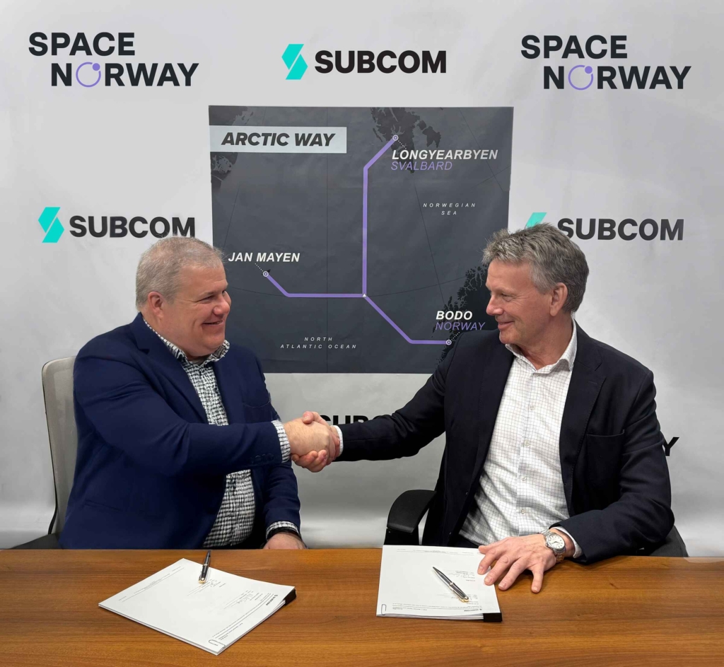 David Coughlan, CEO of SubCom, and Morten Tengs, CEO of Space Norway, sign the contract for the Arctic Way Cable System. (Photo courtesy of SubCom).